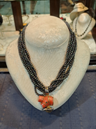 Necklace in Black Tahitian Pearls with sterling silver elements and a Coral Pendant with brilliants and 18k elements