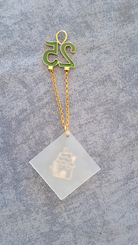 Sterling silver charm on plexiglass - House