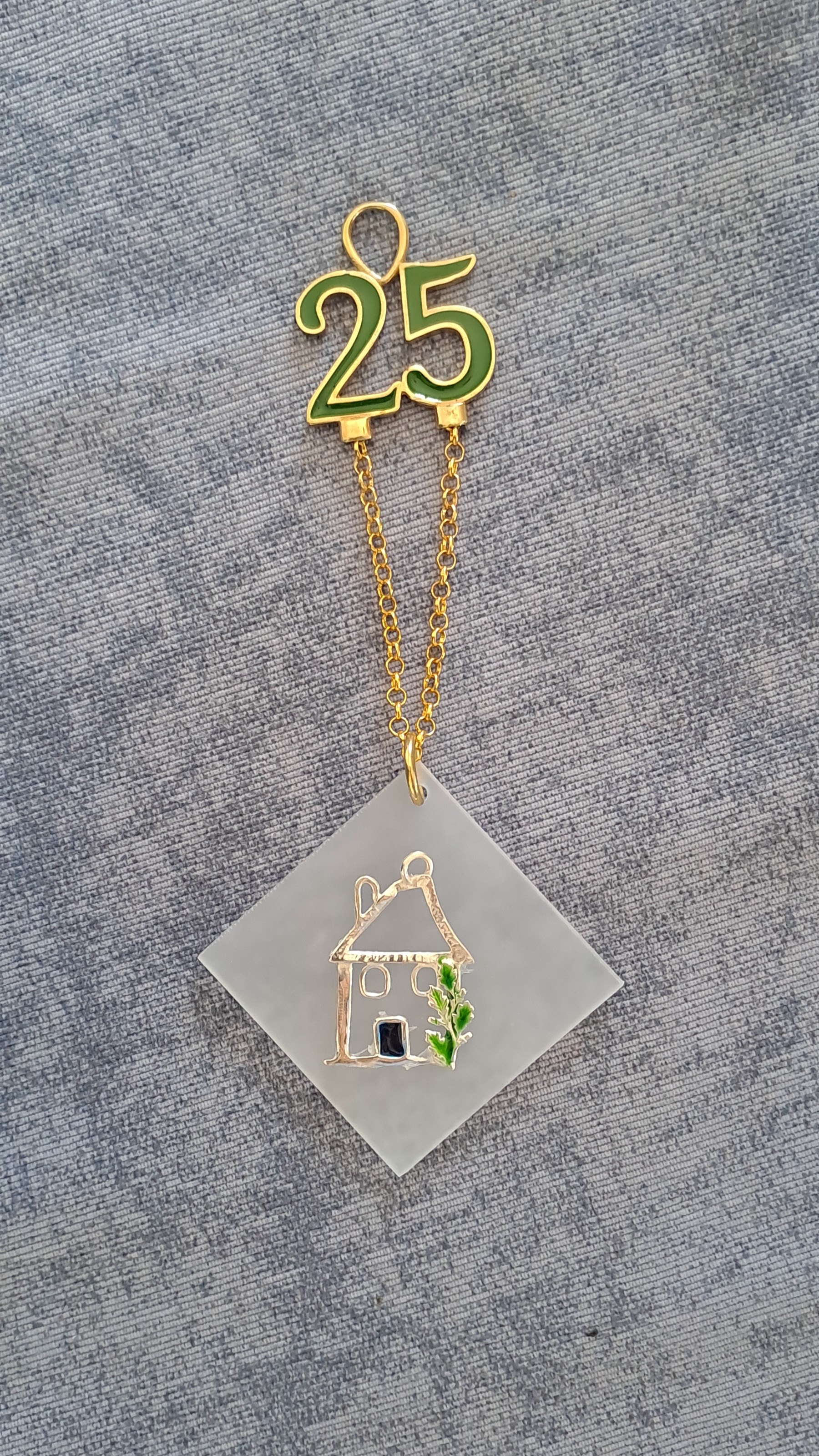 Sterling silver charm on plexiglass - House